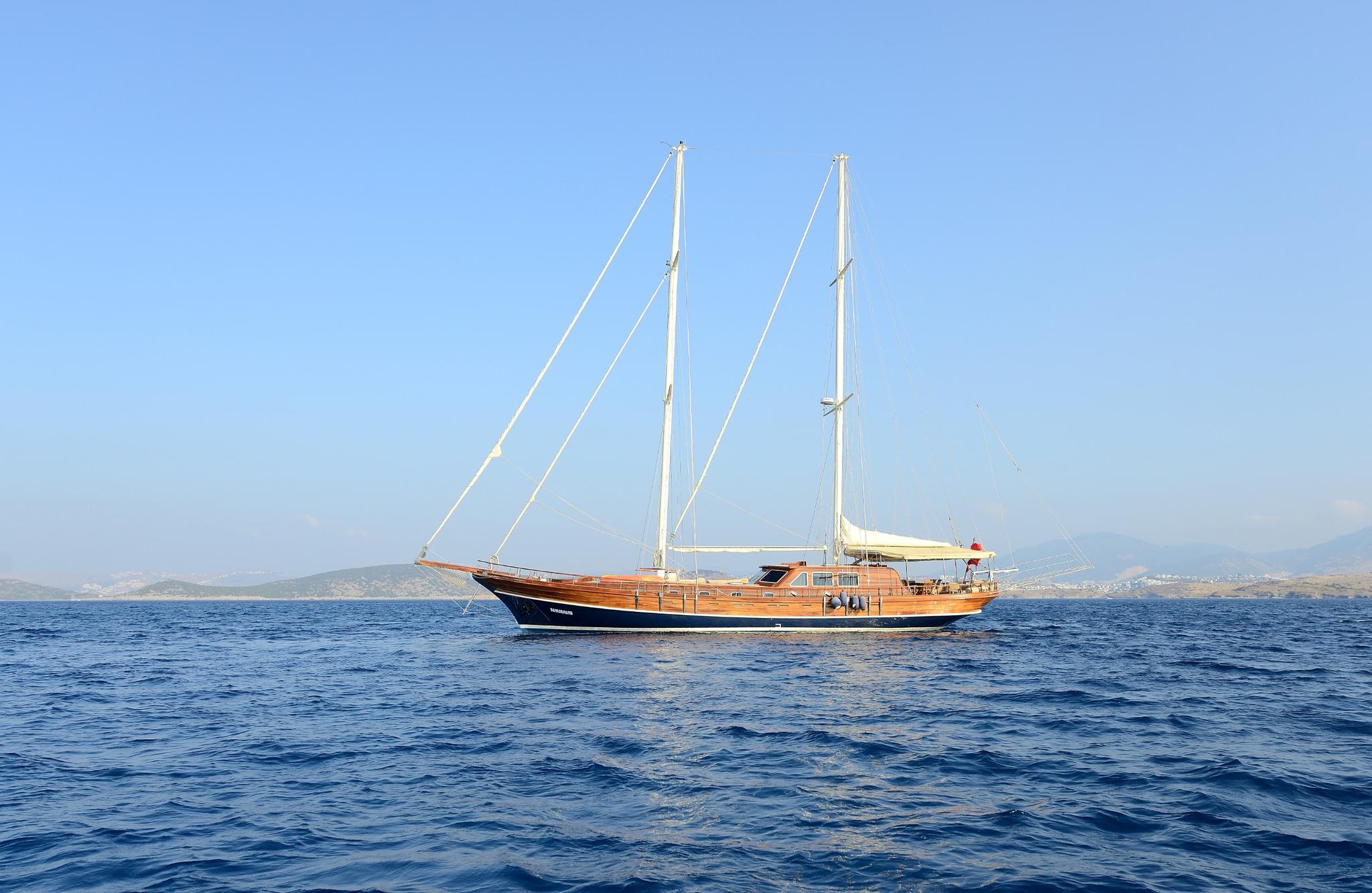 Traditional wooden gulet with two masts anchored on calm blue Mediterranean waters