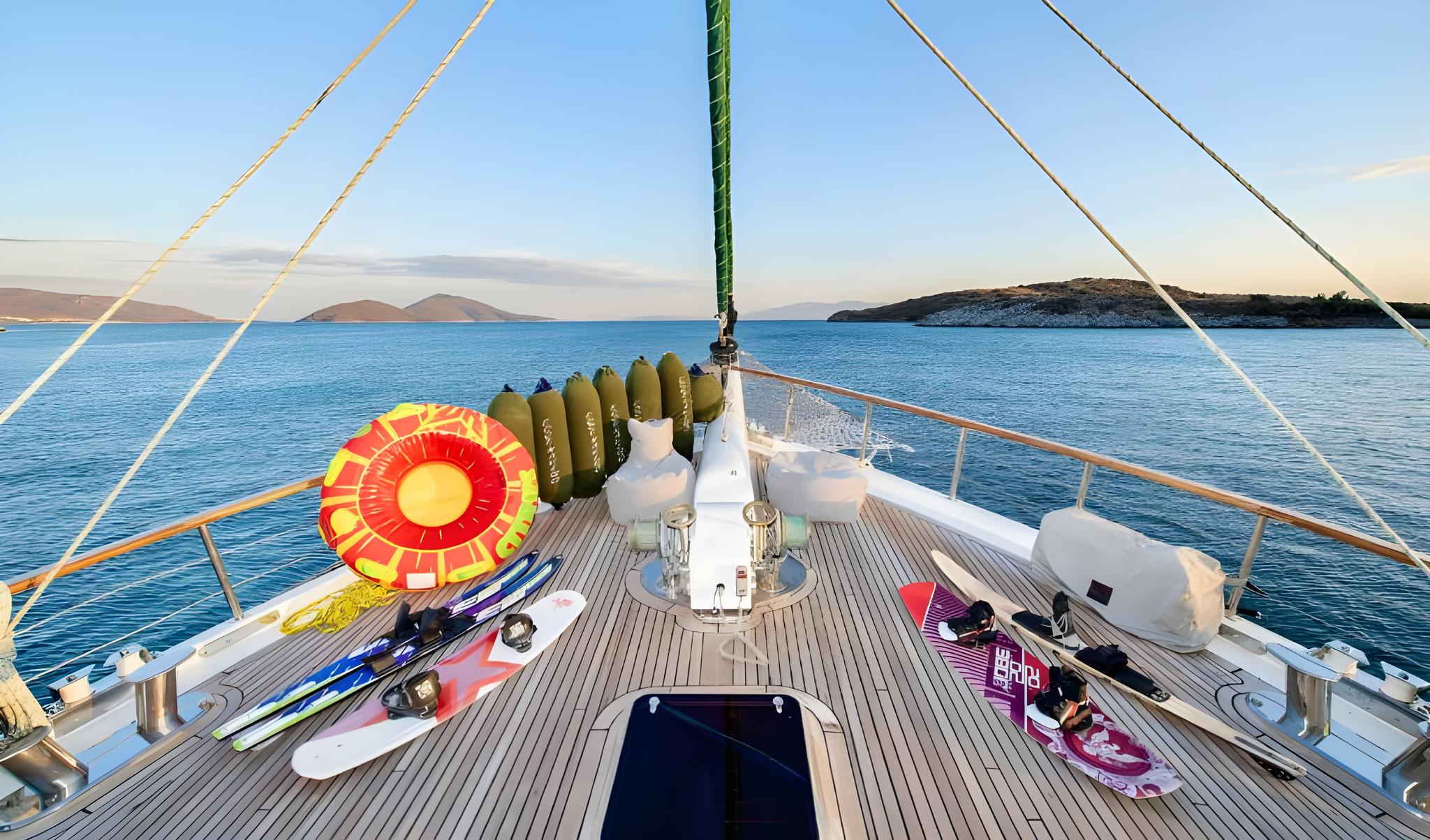 yacht bow deck with inflatable donut, water skis and various water sports equipment