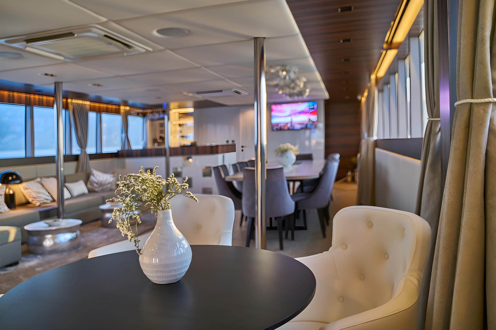 elegant yacht main salon with formal dining area and comfortable seating