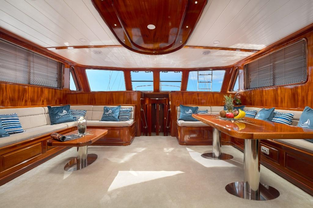 luxury yacht salon with mahogany wood paneling and built-in seating