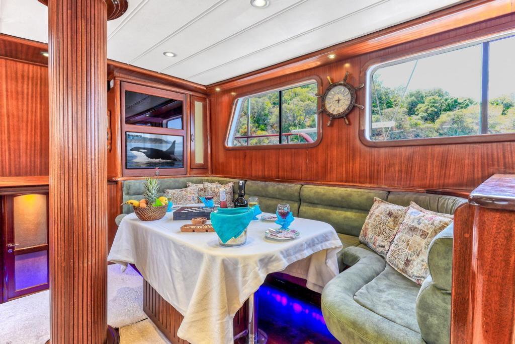 yacht dining saloon with set table featuring blue glassware and served refreshments