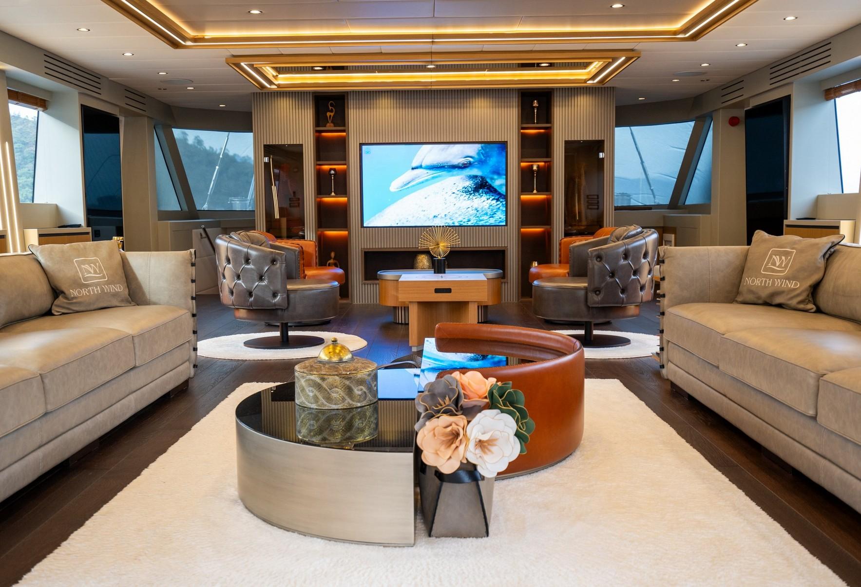 luxury yacht cinema room with wall-mounted screen, leather swivel chairs, and ambient lighting