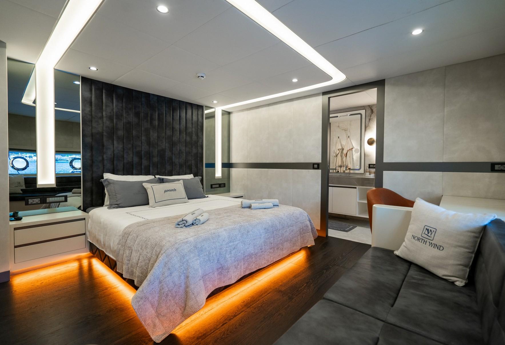 luxurious yacht master cabin with floating bed, LED lighting, dark headboard and ensuite bathroom