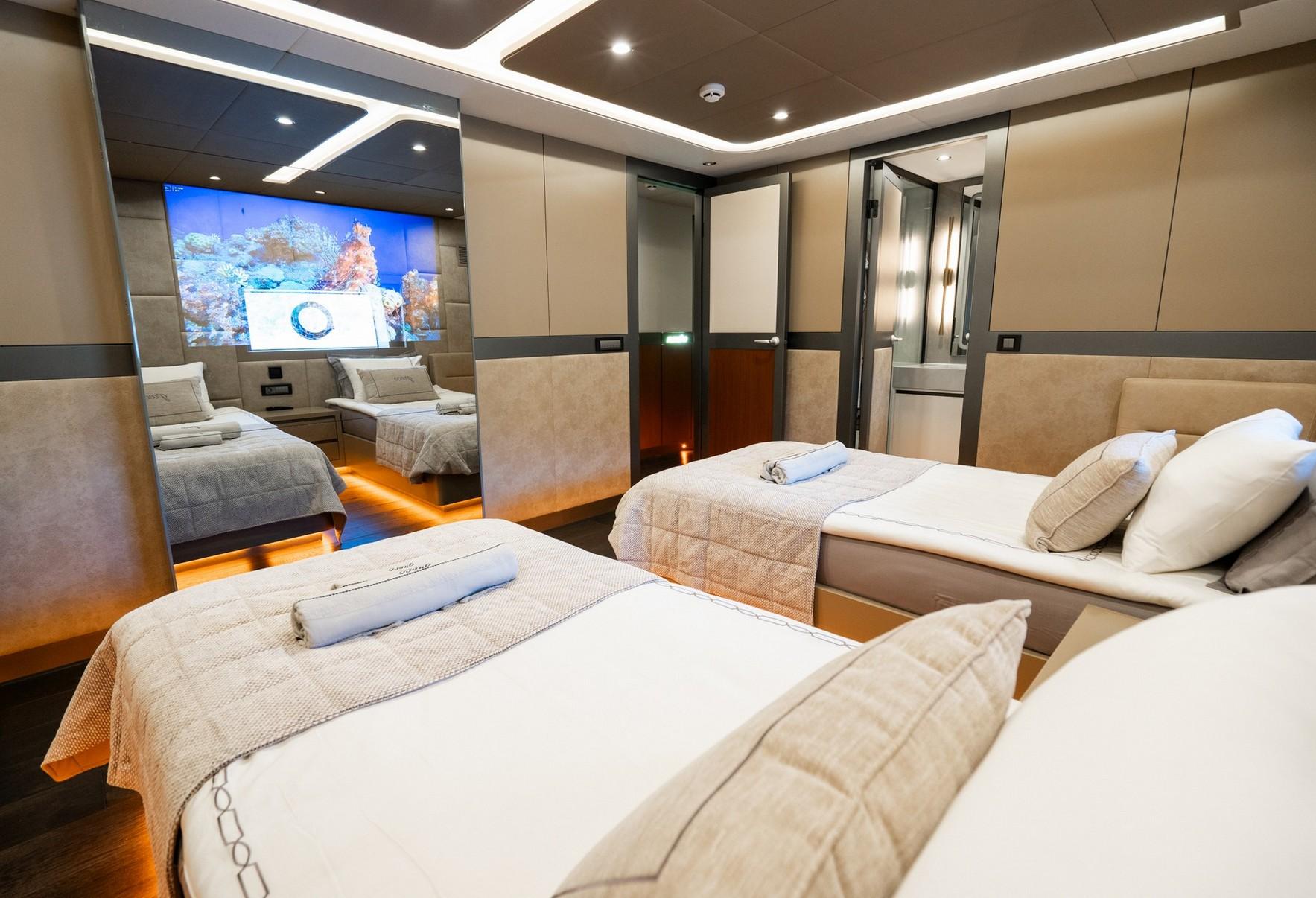 luxury yacht cinema room with large wall-mounted screen showing underwater footage and comfortable seating