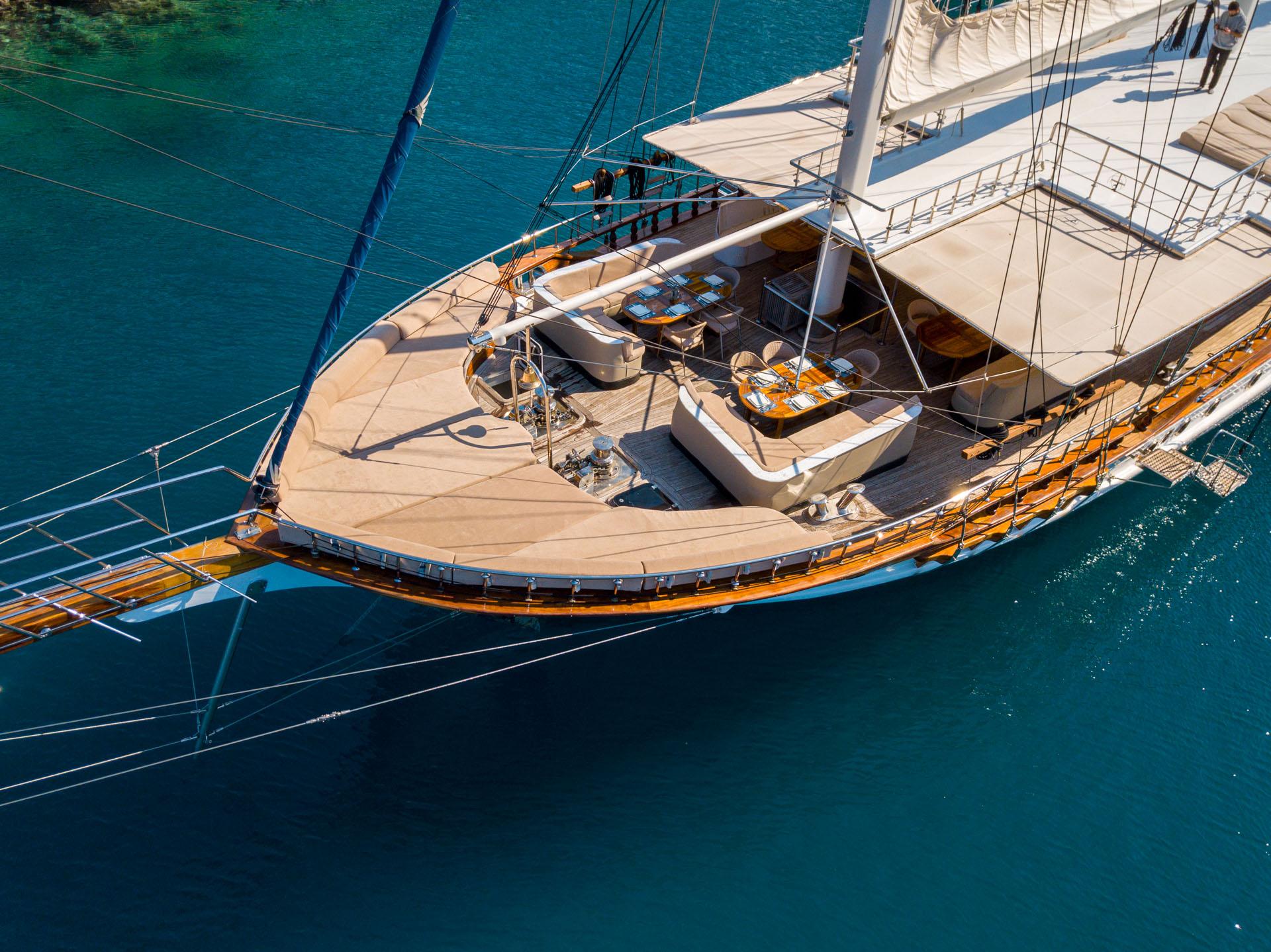 aerial view of luxury sailing gulet showing teak decks, rigging, and turquoise waters