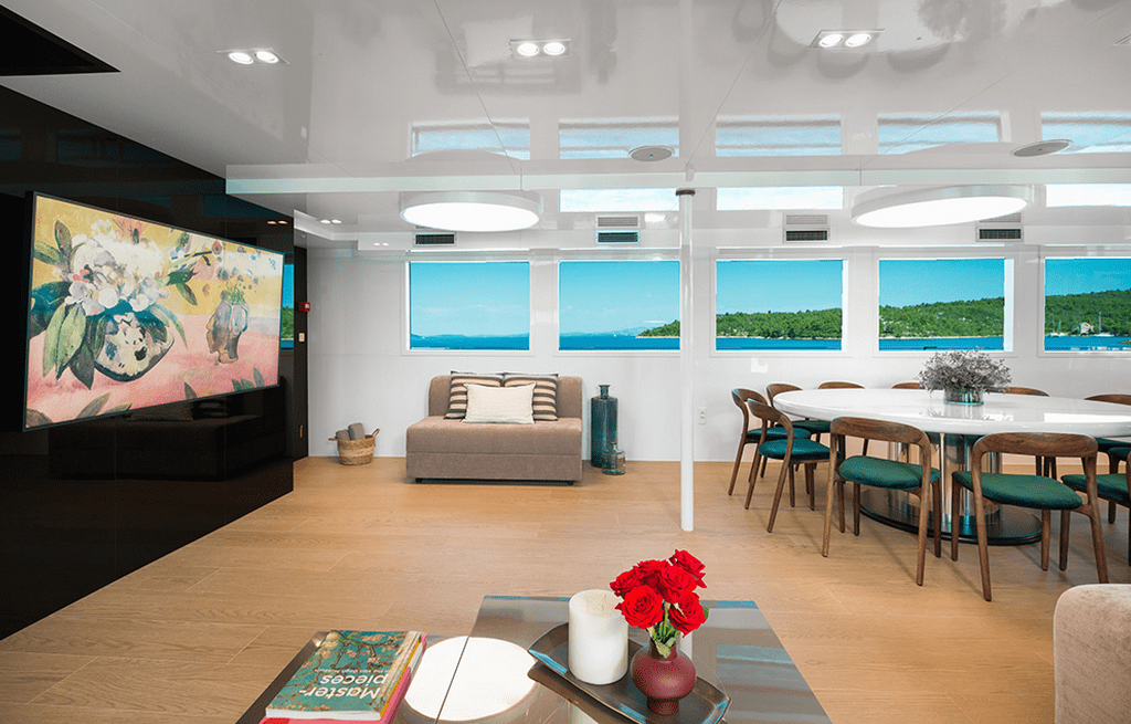 luxury yacht main salon with dining area and panoramic ocean views