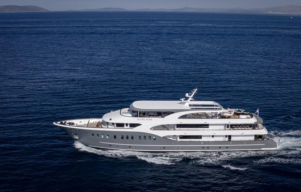 Aerial view of luxury motor yacht Agape Rose cruising blue Mediterranean waters