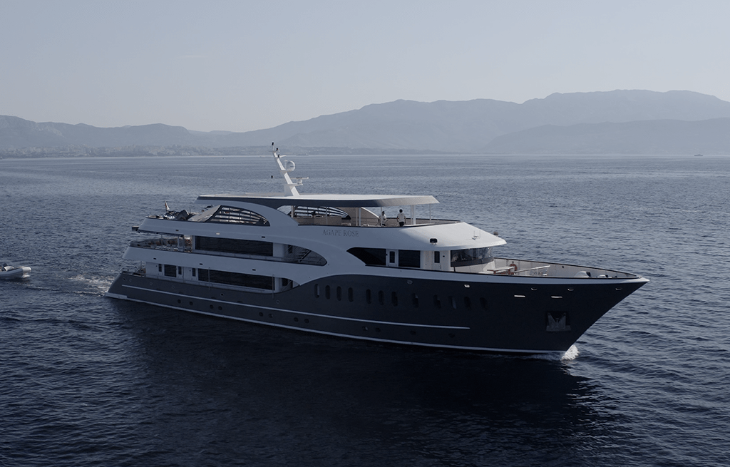 Large luxury motor yacht with navy hull and white superstructure on calm water