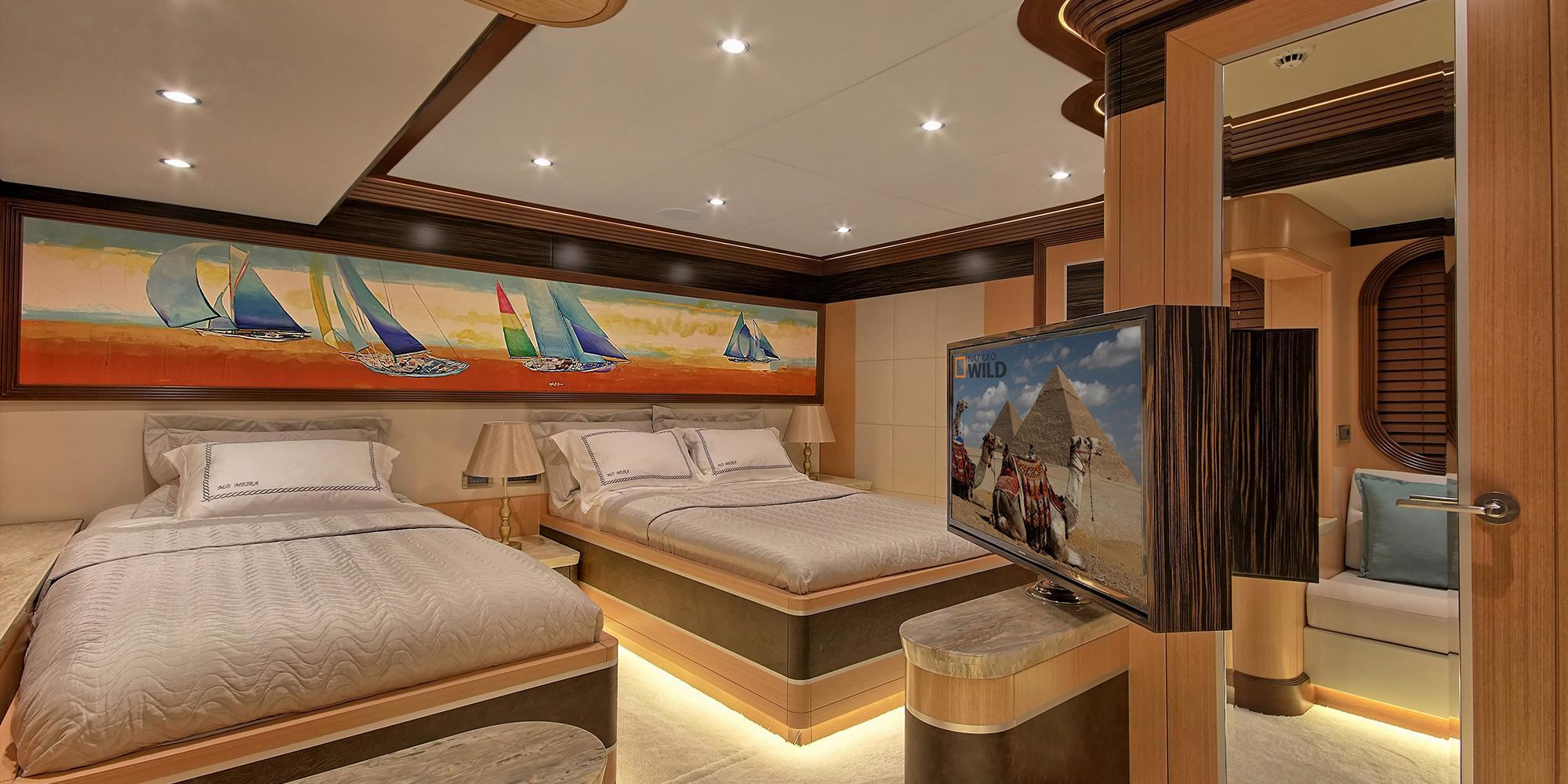 luxury yacht cinema room with large TV screen showing documentary and comfortable seating areas