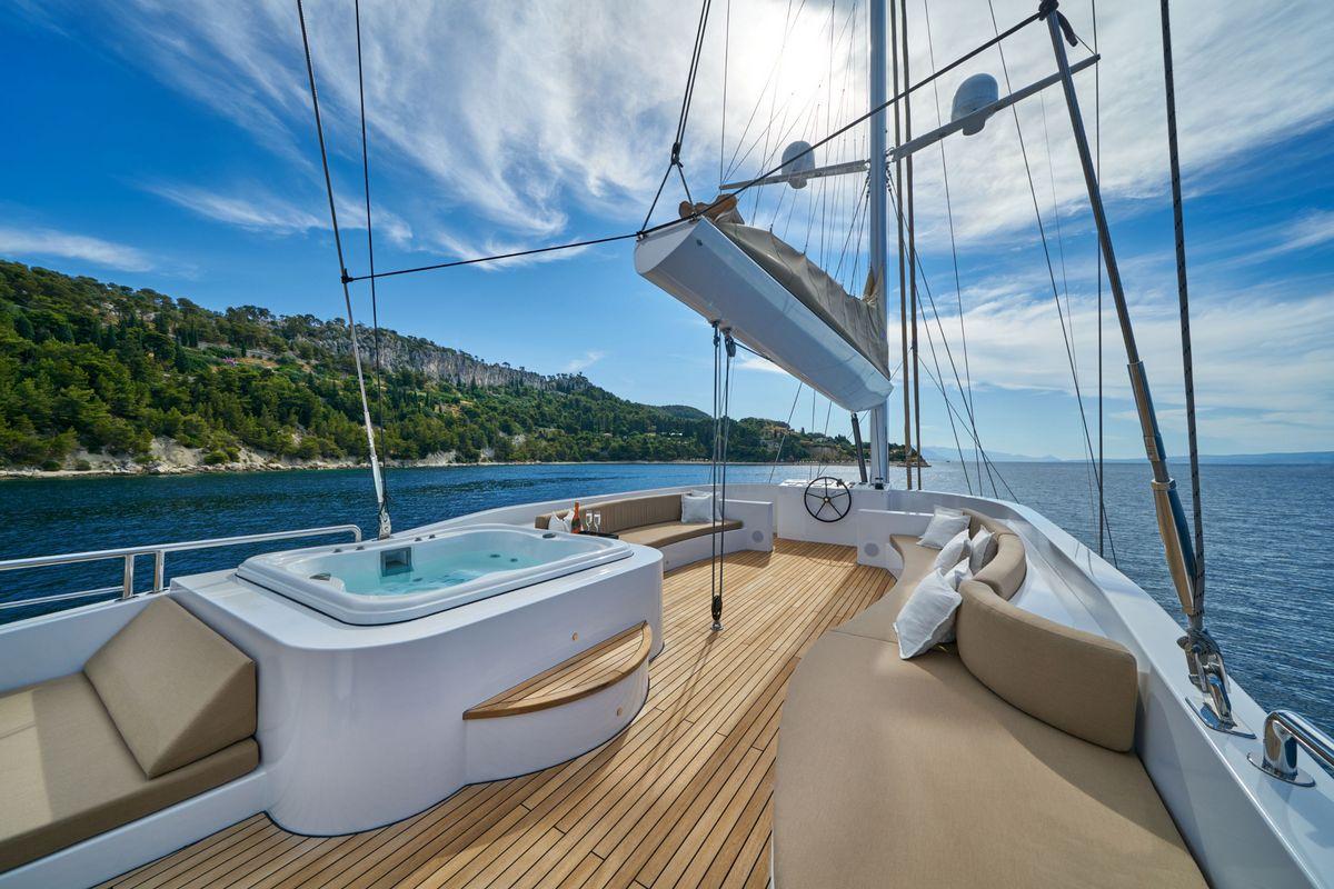 luxury yacht upper deck jacuzzi hot tub teak decking Mediterranean coastline