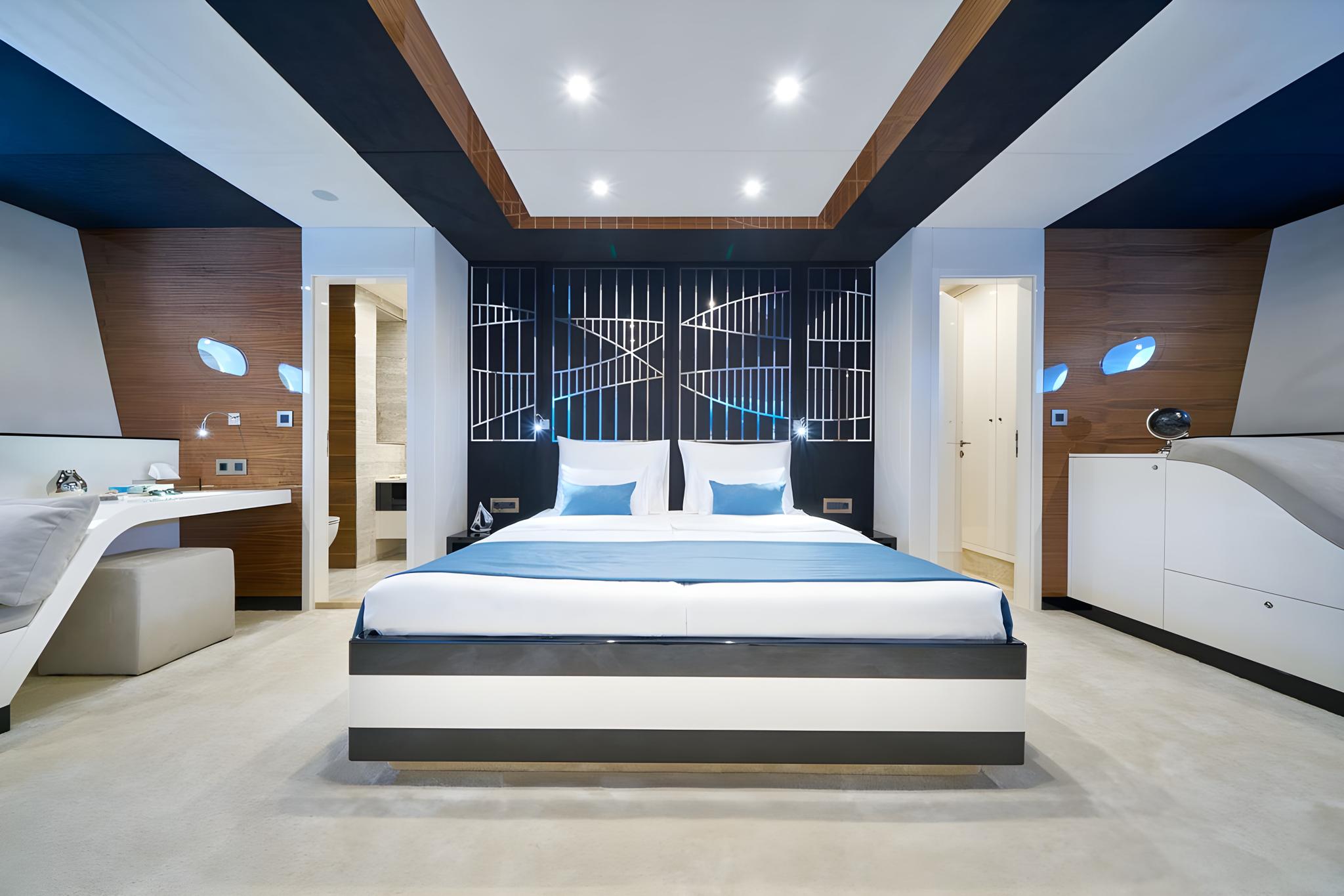 Modern yacht master cabin featuring geometric headboard and sophisticated ceiling design