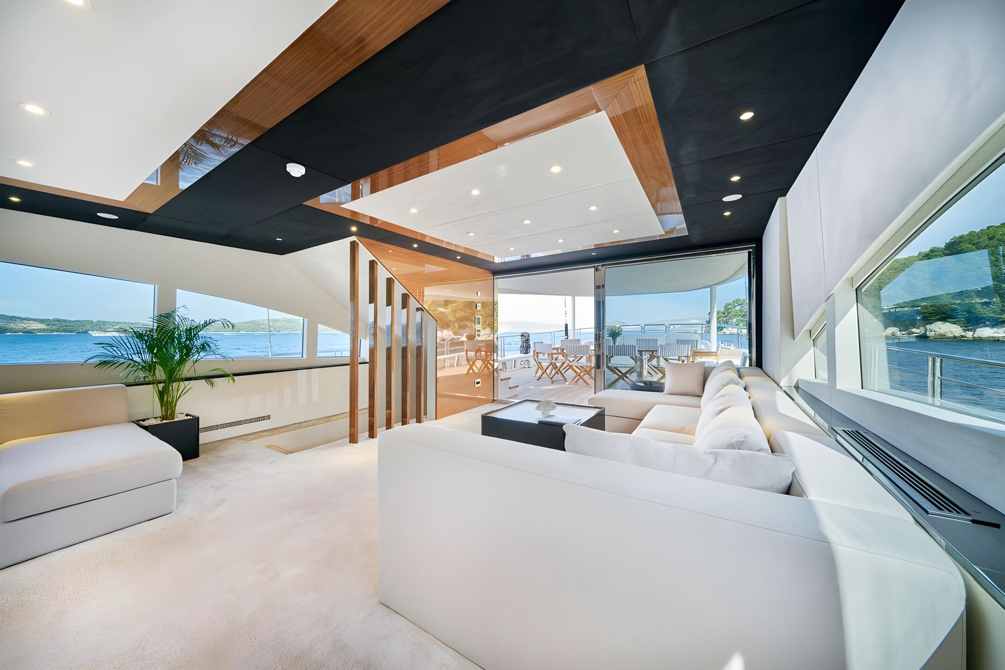 luxury yacht main salon with sectional seating and panoramic ocean views