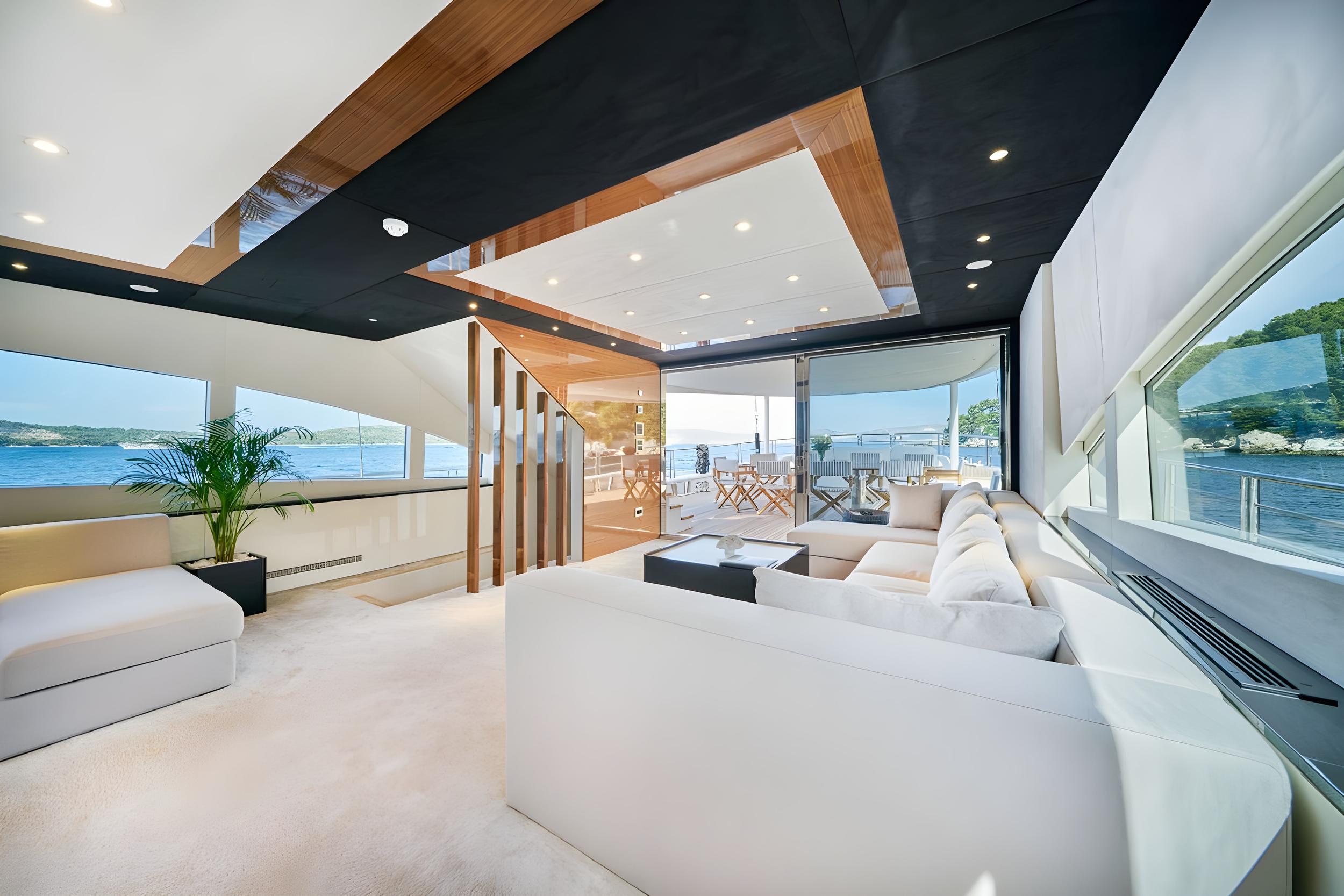 luxury yacht main salon with sectional seating and panoramic ocean views